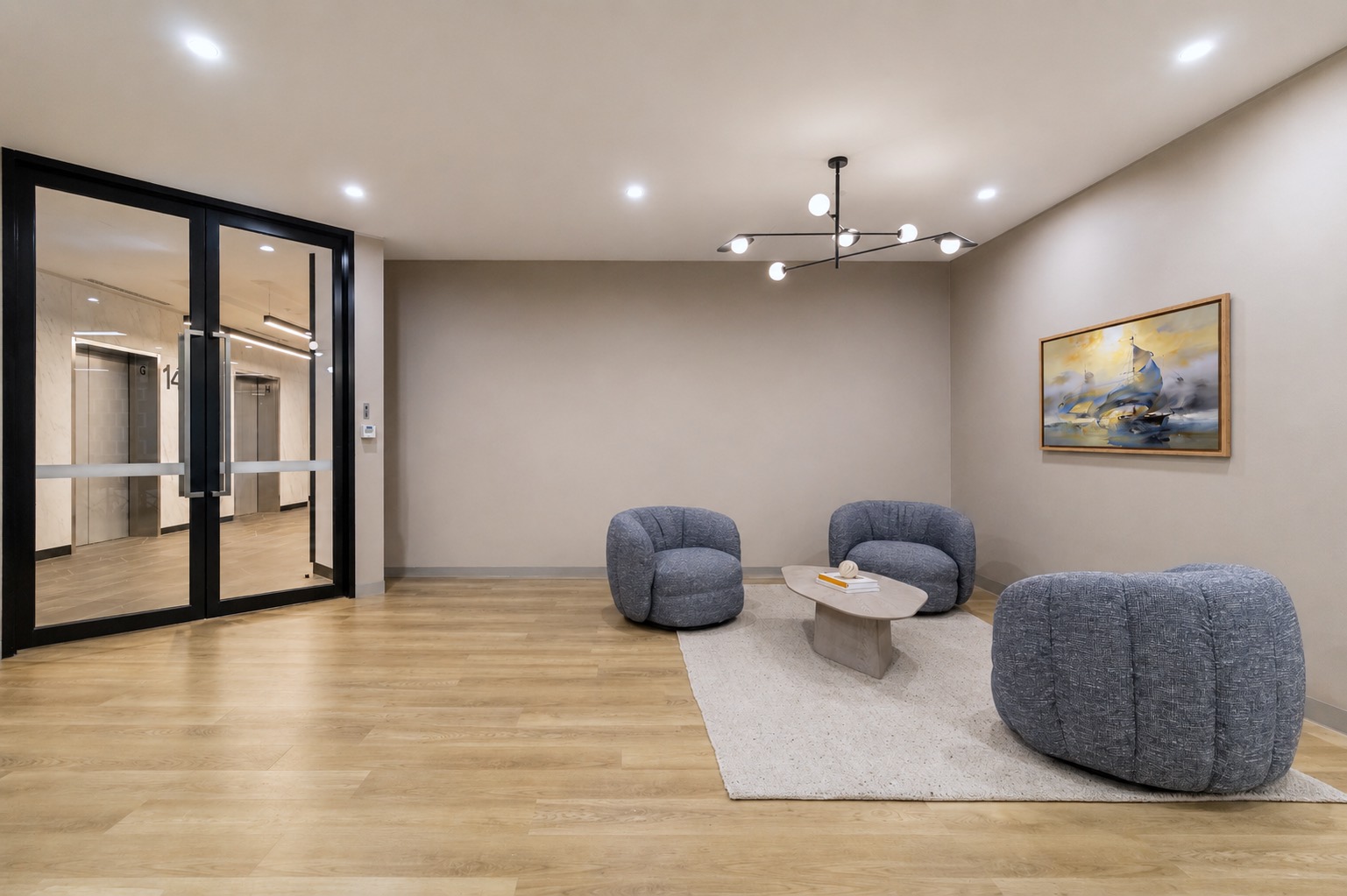 Reception of the Level 14 suite, with its own entry doors and the lift lobby beyond